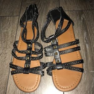 Women’s black sandals with gold accessories